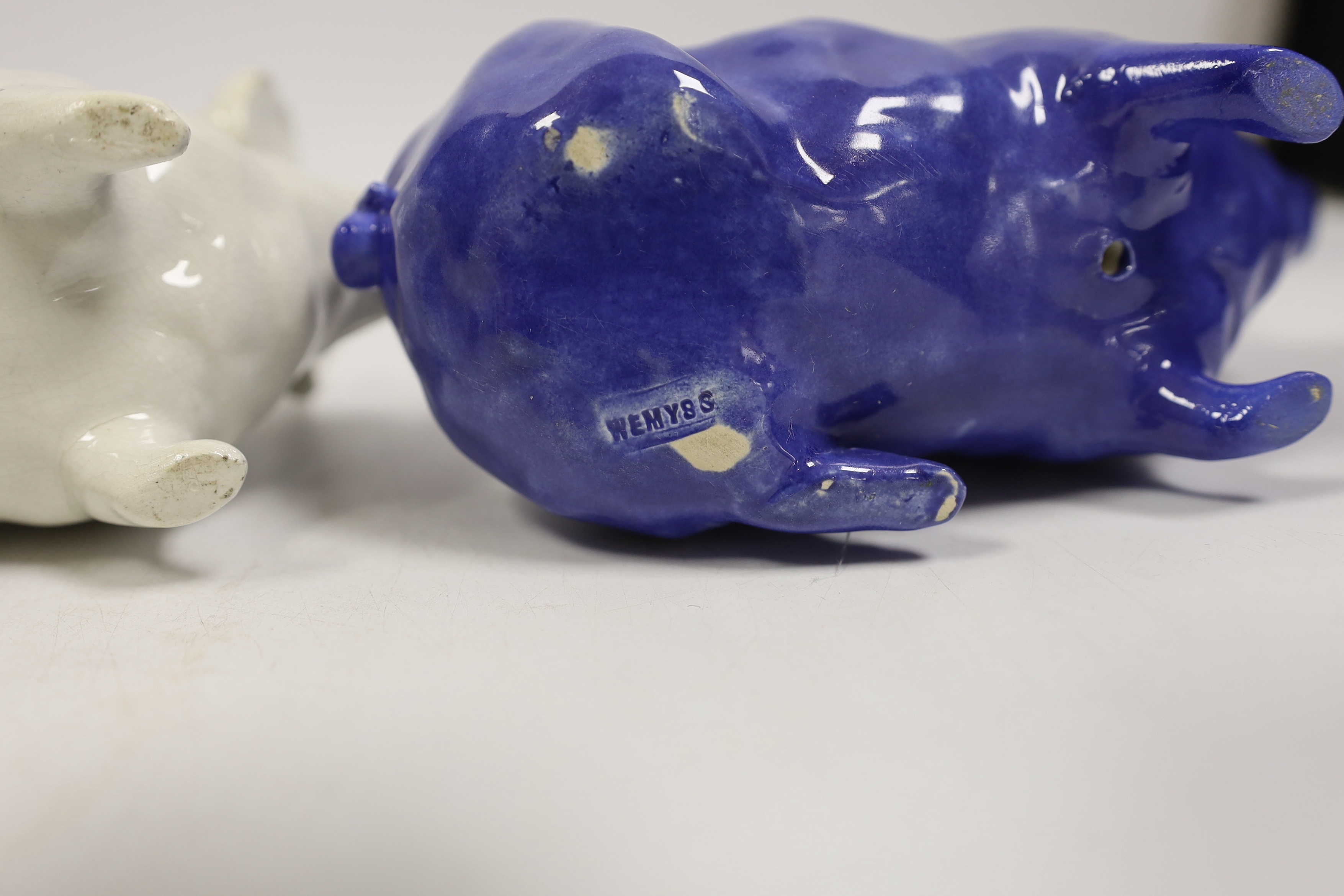 Three Wemyss ware pigs in cream, blue and pink glazes, 15cm